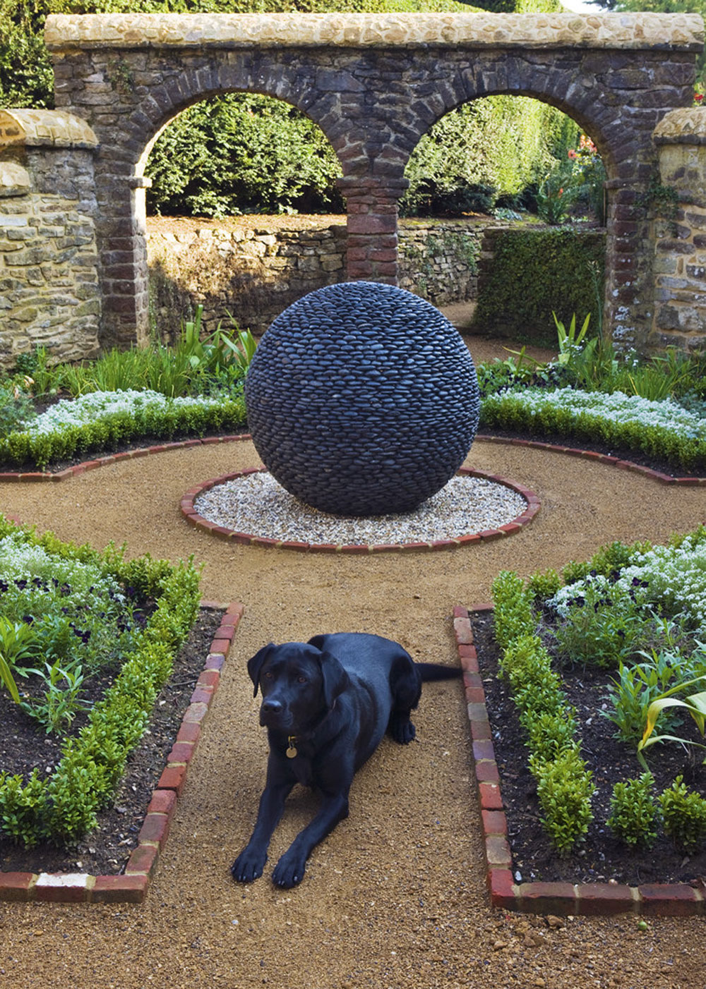 Dark-Planet-garden-sculpture-in-traditional-style-courtyard-by-David-Harber Landscaping rocks to create the perfect rock garden design