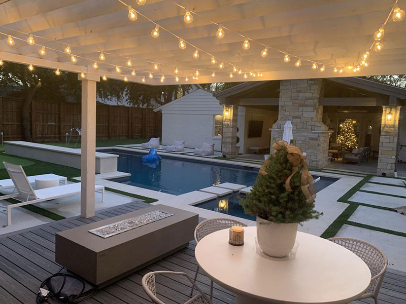 Elementi-Fire-Pit-On-Deck-With-Pool Above Ground Pool Ideas That You Can Try On a Budget