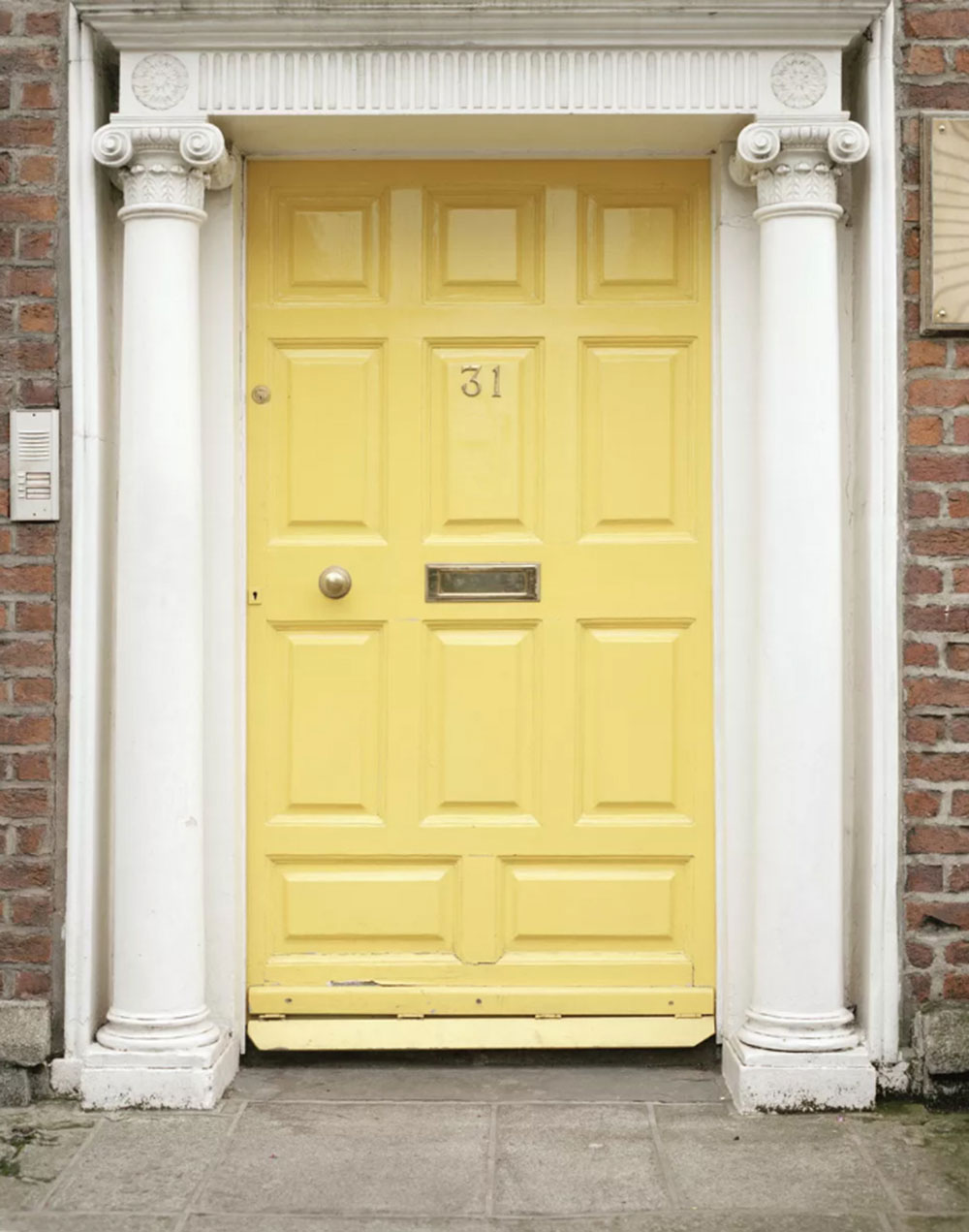 Neoclassical-Yellow-Door Yellow front door ideas for a vivid house entrance