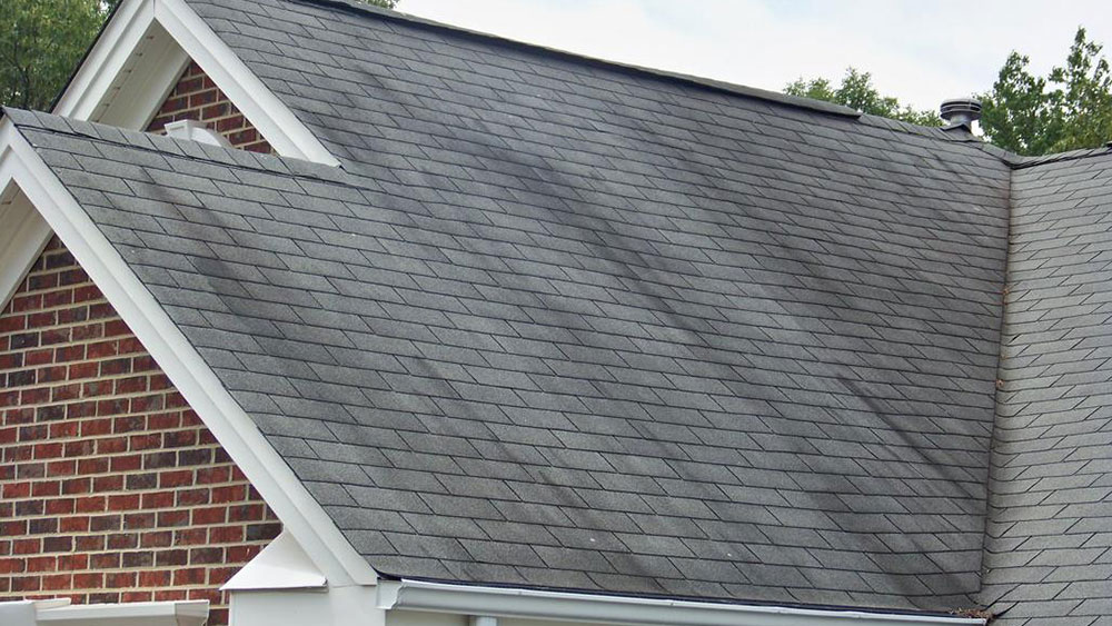 Dark-stripes-on-the-roof How long do asphalt shingles last and when you should change them
