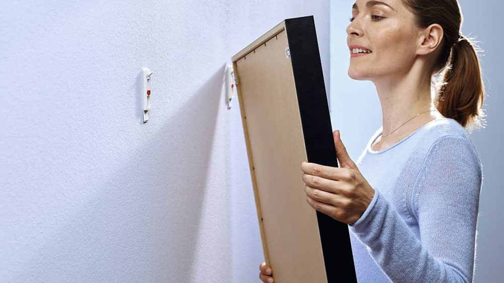 adhesive3 How to hang pictures on plaster walls and have them stick there