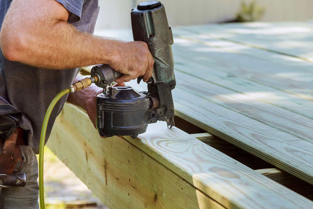 Nail-gun-and-air-compressor What Tools Do I Need to Build a Deck? (Answered)