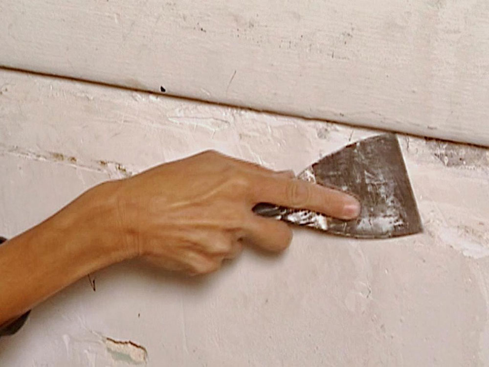 Begin-with-scraping-the-wall How to smooth textured walls like a pro