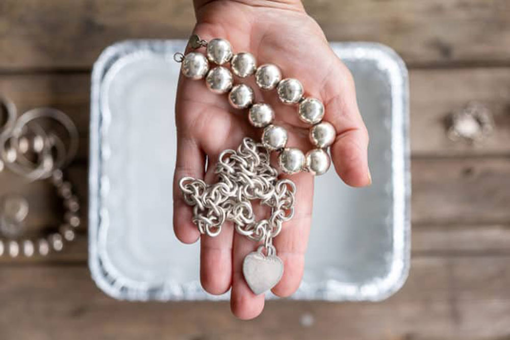 Clean-your-silver-jewelry What to Do With Fire Pit Ash Without Just Throwing It Away (Answered)