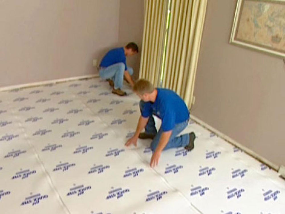 Place-an-underlayment2 How to install laminate flooring on a concrete basement floor